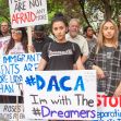 Protesters holding signs supporting DACA and Dreamers during a rally. Protesters holding signs supporting DACA and Dreamers during a rally.