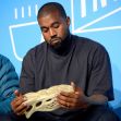 Kanye West examining a Yeezy Foam Runner shoe during a presentation. Kanye West examining a Yeezy Foam Runner shoe during a presentation.