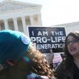 Pro-life demonstrators outside the Supreme Court holding signs advocating against abortion rights. Pro-life demonstrators outside the Supreme Court holding signs advocating against abortion rights.