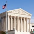 The United States Supreme Court building with an American flag flying in front. The United States Supreme Court building with an American flag flying in front.