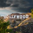 The iconic Hollywood sign surrounded by hills and trees under a dramatic sky. The iconic Hollywood sign surrounded by hills and trees under a dramatic sky.