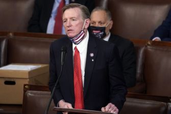 A Republican lawmaker, Paul Gosar, addressing the House of Representatives while wearing a mask during a censure vote.