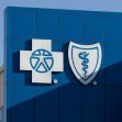 Logo of Blue Cross Blue Shield on the exterior of a building. Logo of Blue Cross Blue Shield on the exterior of a building.