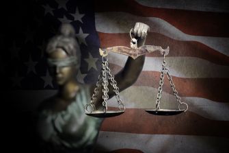 A representation of Lady Justice holding scales against the backdrop of the American flag, symbolizing the judicial system.