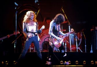 Led Zeppelin performing on stage, featuring lead vocalist Robert Plant and guitarist Jimmy Page.
