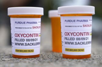 Prescription bottles labeled with "OxyContin" from Purdue Pharma, associated with the Sackler family.