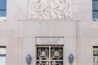 Facade of the Federal Trade Commission building with a decorative relief above the entrance.
