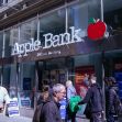 Apple Bank branch in New York City with pedestrians walking by. Apple Bank branch in New York City with pedestrians walking by.