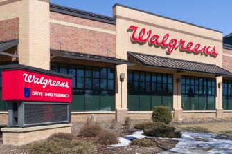 Exterior view of a Walgreens store with a drive-thru pharmacy sign.