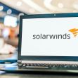 Laptop displaying the SolarWinds logo in a public setting. Laptop displaying the SolarWinds logo in a public setting.
