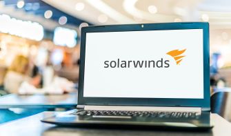 Laptop displaying the SolarWinds logo in a public setting.