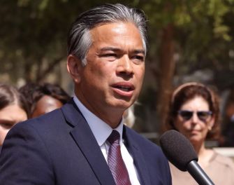 California Attorney General Rob Bonta speaking at a press conference, addressing the lawsuit against the Trump administration regarding funding cuts to medical research.