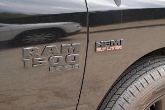 Close-up of the badge on a black RAM 1500 Classic featuring the HEMI 5.7 liter engine.