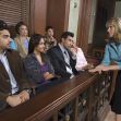 A diverse jury seated in a courtroom, listening to an attorney during a trial. A diverse jury seated in a courtroom, listening to an attorney during a trial.
