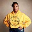 Patrisse Khan-Cullors, co-founder of the Black Lives Matter movement, poses in a yellow hoodie with the word "QUEEN." Patrisse Khan-Cullors, co-founder of the Black Lives Matter movement, poses in a yellow hoodie with the word "QUEEN."