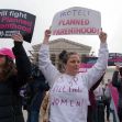 Demonstrators holding signs in support of Planned Parenthood outside the Supreme Court during a protest. Demonstrators holding signs in support of Planned Parenthood outside the Supreme Court during a protest.