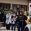 First responders assist individuals after a mass shooting incident, with police and emergency vehicles present. First responders assist individuals after a mass shooting incident, with police and emergency vehicles present.