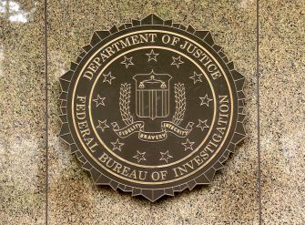 Seal of the Federal Bureau of Investigation (FBI) displayed on a textured backdrop.
