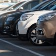 A row of parked vehicles at a dealership. A row of parked vehicles at a dealership.