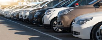 A row of parked vehicles at a dealership.