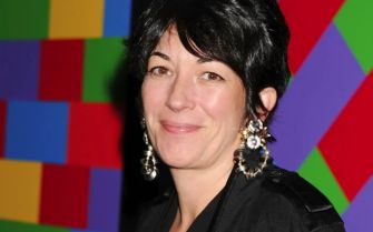 Ghislaine Maxwell at an event, smiling, with a colorful background.