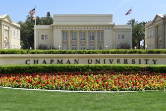 The exterior view of Chapman University, showcasing its main building and landscaped gardens.