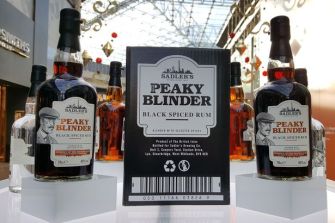 Bottles of Sadler's Peaky Blinder Black Spiced Rum displayed in a promotional setting.