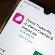 Image of the Flo fertility tracking app's page on a smartphone, featuring the app's logo and title. Image of the Flo fertility tracking app's page on a smartphone, featuring the app's logo and title.