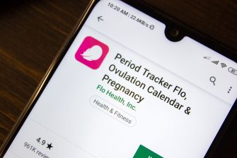 Image of the Flo fertility tracking app's page on a smartphone, featuring the app's logo and title.