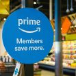 Sign advertising Amazon Prime membership benefits in a grocery store setting. Sign advertising Amazon Prime membership benefits in a grocery store setting.