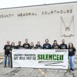A group of Greenpeace supporters standing outside the Morton County Memorial Courthouse, holding a banner that reads "ENERGY TRANSFER: WE WILL NOT BE SILENCED." A group of Greenpeace supporters standing outside the Morton County Memorial Courthouse, holding a banner that reads "ENERGY TRANSFER: WE WILL NOT BE SILENCED."