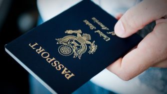 A person holds a U.S. passport, symbolizing the introduction of the first non-binary gender marker.