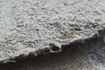 Close-up view of asbestos fibers on a surface.