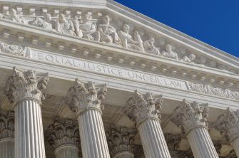 Image of the U.S. Supreme Court building, featuring the inscription "Equal Justice Under Law" above its columns.