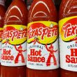 Bottles of Texas Pete hot sauce displayed on a store shelf. Bottles of Texas Pete hot sauce displayed on a store shelf.