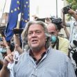 Steve Bannon surrounded by media outside a public event, gesturing and speaking while wearing a mask. Steve Bannon surrounded by media outside a public event, gesturing and speaking while wearing a mask.