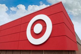 Target store exterior featuring its iconic logo against a cloudy sky.