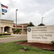 Sign for U.S. Customs and Border Protection Border Patrol Station in Harlingen, Texas, with flags in the background. Sign for U.S. Customs and Border Protection Border Patrol Station in Harlingen, Texas, with flags in the background.