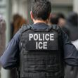 A law enforcement officer wearing an "ICE" vest is seen in a crowded area. A law enforcement officer wearing an "ICE" vest is seen in a crowded area.