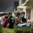 Authorities assist an individual during a human smuggling investigation in Houston, where multiple migrants were found in a residential home. Authorities assist an individual during a human smuggling investigation in Houston, where multiple migrants were found in a residential home.