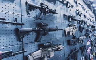 A display of various assault weapons on a wall in a gun store.