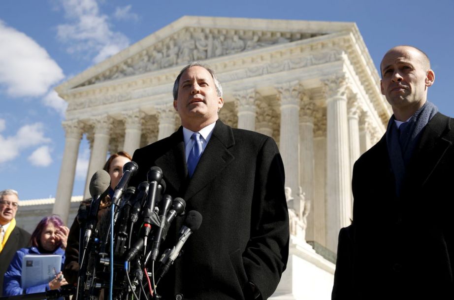 Texas Attorney General Ken Paxton addresses reporters on the steps of the U.S. Supreme Court in 2016. The high court declined to hear a lawsuit Paxton's office filed against California over its ban on state-sponsored travel here. Credit: REUTERS/Kevin Lamarque