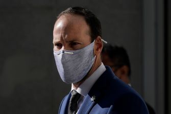 Former San Francisco Police Officer Chris Samayoa, charged with manslaughter, wearing a mask and formal attire.