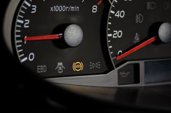 Image of a car dashboard showing illuminated indicators, including the ABS warning light.