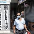 A man wearing a mask walks past a street mural calling for the cancellation of rent during the COVID-19 pandemic. A man wearing a mask walks past a street mural calling for the cancellation of rent during the COVID-19 pandemic.