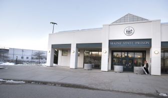 Exterior view of the Maine State Prison, highlighting the main entrance and surrounding area.