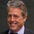 A smiling middle-aged man with gray hair, dressed in a dark suit and light shirt, poses for the camera. A smiling middle-aged man with gray hair, dressed in a dark suit and light shirt, poses for the camera.