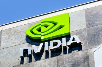 Nvidia logo displayed on the exterior of a building against a blue sky.