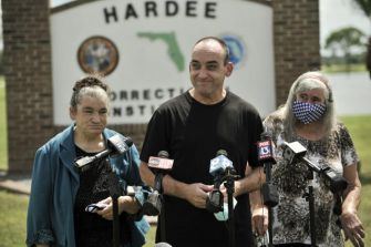 Robert DuBoise, recently exonerated after 37 years in prison, speaks at a press conference outside the Hardee Correctional Institution in Florida, flanked by supporters.