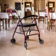 A walker placed in an empty dining area of a nursing home. A walker placed in an empty dining area of a nursing home.